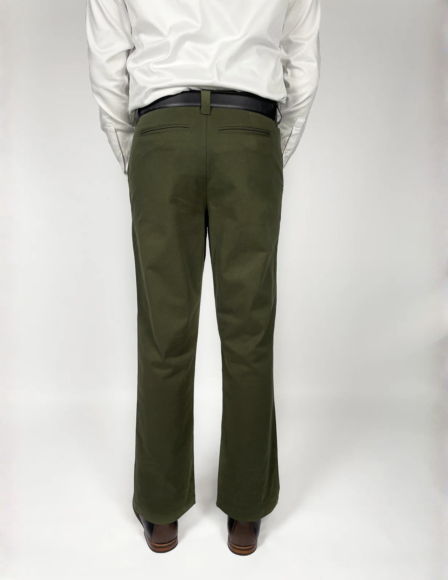 Man wearing All That Chino style pants and a white shirt on a white background