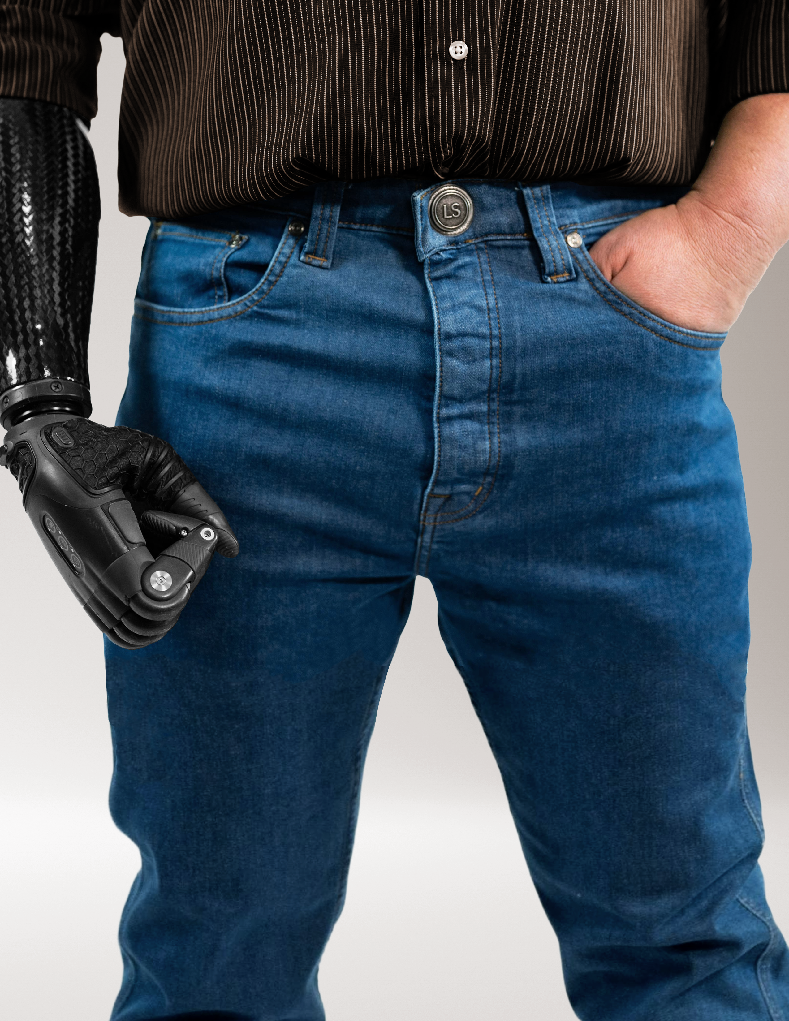 Man wearing Jeanius Denim style pants and a black shirt with a white background