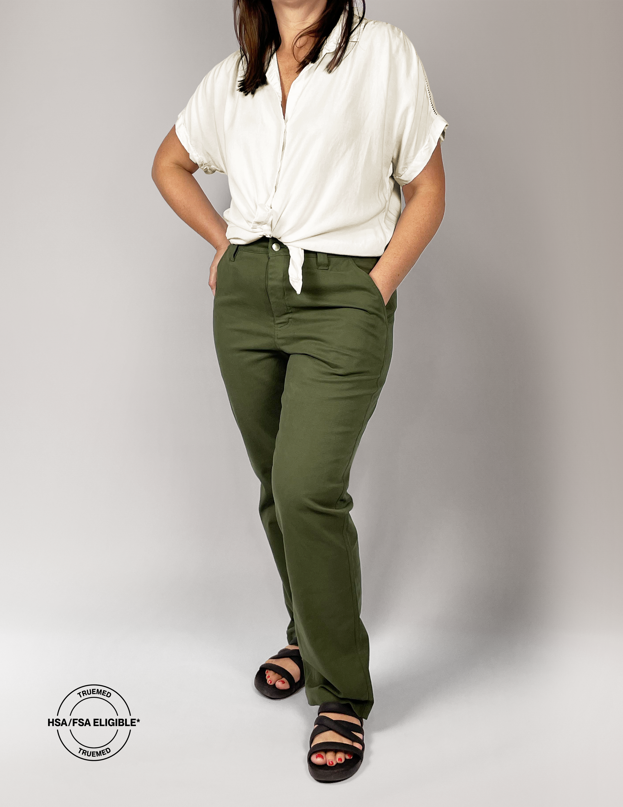 Woman wearing a white shirt and All That Chino style pants on a gray background