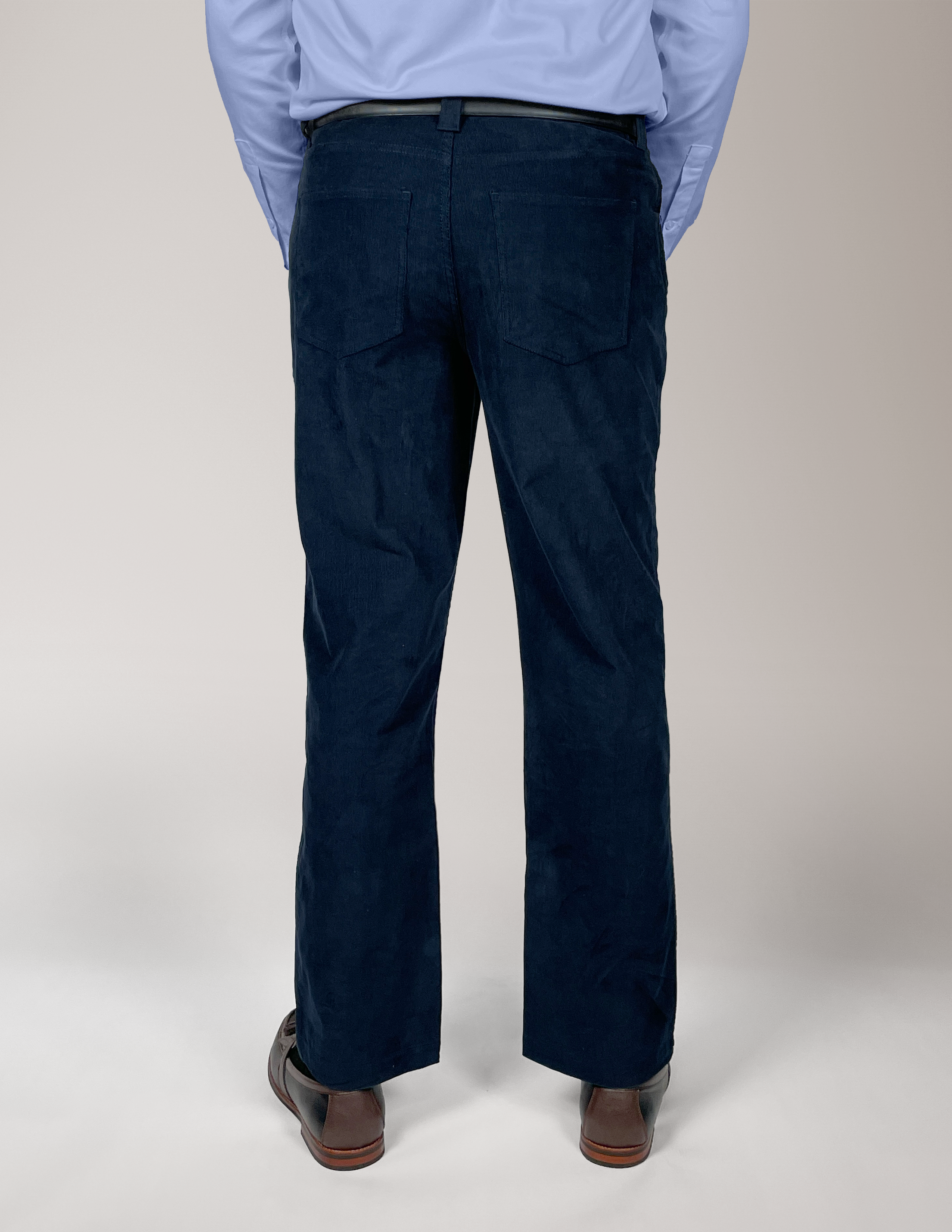 Man wearing Cordster style pants with a plain background